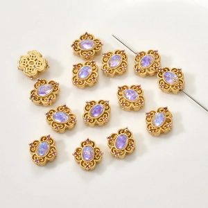 Macro detail of retro gold-plated beads with iris gemstones and red rhinestones