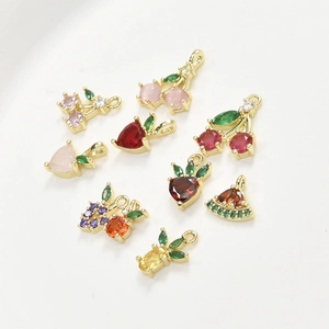 Macro shot of 14k gold-plated fruit charms with colorful cubic zirconia for jewelry making