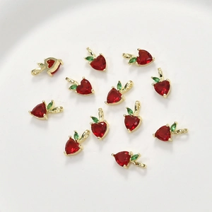 Macro view of 11 red heart-shaped strawberry pendants with gold-plated green leaf accents