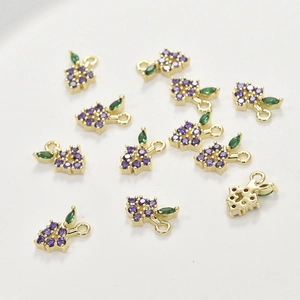 Detail of purple grape pendants with zircon gems and gold-plated ring for DIY jewelry making