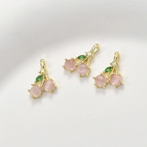 Three pink cat eye cherry pendants with green zircon leaves in 14k gold plated finish
