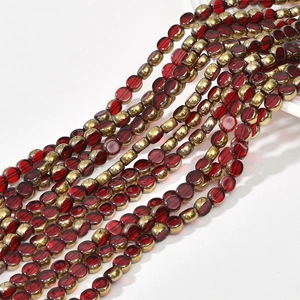 Macro detail of red striped glass beads and gold plated metal spacers for DIY jewelry