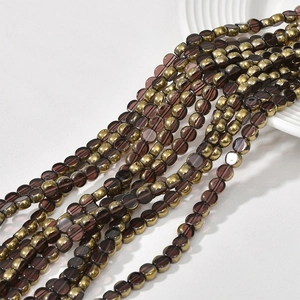 Close-up of flat round purple and gold crystal glass beads for DIY jewelry making