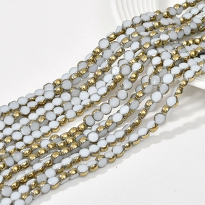 Detail shot of flat round 6mm crystal glass beads with gold plated edges for DIY jewelry