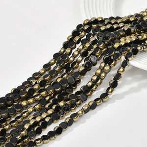 Close-up of 6mm faceted flat round glass crystal beads with gold plating for jewelry DIY