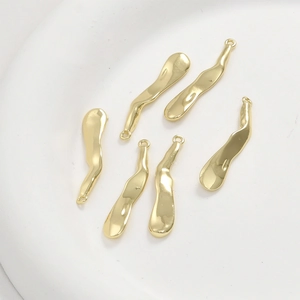 Macro detail of 14k gold plated irregular bar pendants for DIY jewelry making accessories