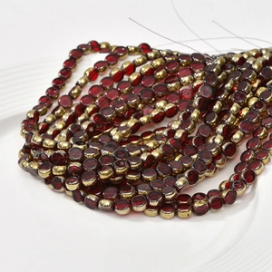 Close-up of 6mm red crystal glass beads with gold spacers for DIY jewelry making