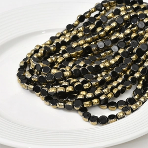 Close-up of 6mm flat round crystal glass beads with gold plated edges for DIY jewelry crafts