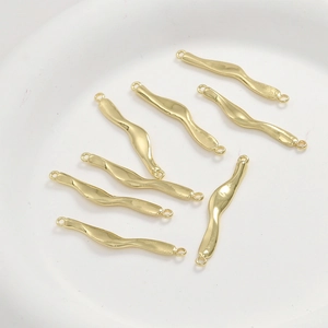 Detail of 14k gold plated wavy bar connectors with double loops for DIY jewelry making