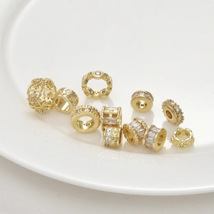 Macro view of gold-plated spacer beads with inlaid zircons for DIY jewelry making