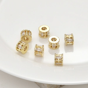 Macro detail of 14k gold plated cylinder spacer beads with square zirconia inlays