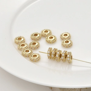 Macro view of 14k gold plated gear spacers with inlaid zircons for DIY jewelry
