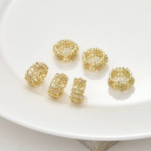 Close-up of six 14k gold plated spacer beads with inlaid zircons for DIY jewelry