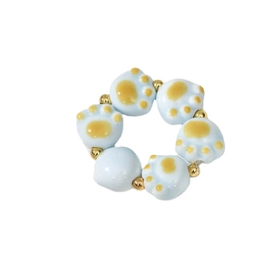 Blue cat paw ceramic beads with gold spacers in a handcrafted beaded stretch ring