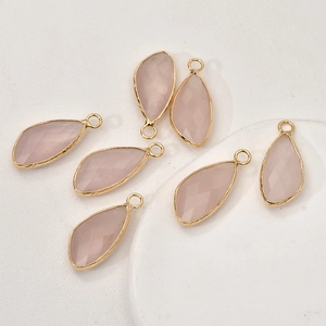 Detail of pink crystal faceted teardrop pendants with gold plated copper edging