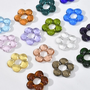 Colorful translucent glass flower beads for DIY jewelry making displayed on white background