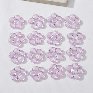 Macro shot of 16 light purple transparent glass flower beads for DIY jewelry making