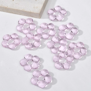 Close-up of semi-transparent light purple DIY glass flower beads for jewelry making