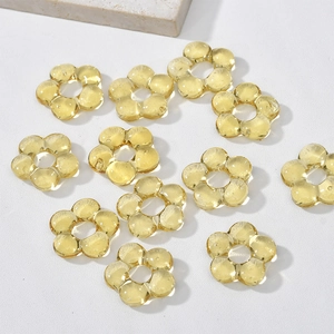 Macro shot of translucent yellow flower resin beads for DIY jewelry and handmade crafts