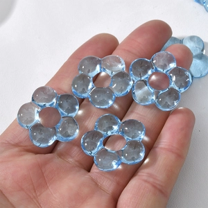 Close-up of a light blue translucent glass flower bead for DIY jewelry making