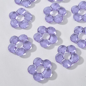 Macro shot of purple translucent five-petal flower beads for DIY handmade jewelry crafts