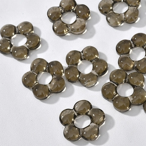 Macro shot of smoky brown translucent flower beads with center holes for DIY jewelry