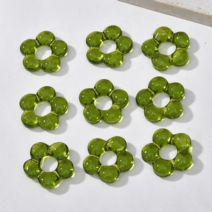 Macro shot of olive green glass flower beads for DIY jewelry making and crafts