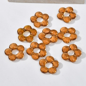Macro view of amber translucent glass flower beads for DIY jewelry and crafts making