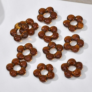 Macro shot of amber translucent flower beads for DIY jewelry and crafts making