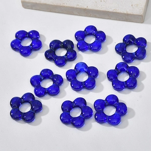 Macro view of ten translucent deep blue glass flower petals for DIY jewelry making