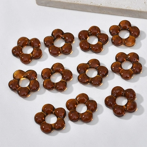 Macro shot of 10 translucent amber glass flower beads for DIY jewelry making