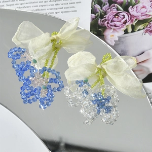 Blue crystal flower handmade earring pendant with beige chiffon bow on mirror