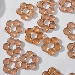 Detailed macro view of amber glass flower beads for handmade jewelry making and crafts