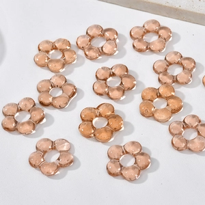 Macro detail of amber transparent glass flower beads for DIY jewelry making and crafts