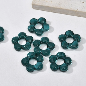 Detailed view of dark teal glass flower beads for DIY jewelry and handmade crafts