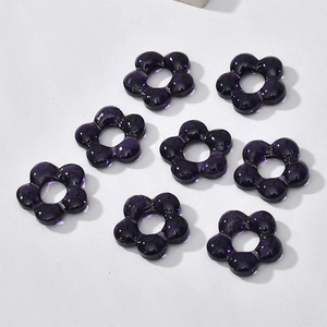 Macro shot of 8 translucent deep purple hollow flower beads for DIY jewelry making