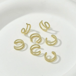 Minimalist 14k gold plated beaded C-shape ear cuffs set on a white ceramic tray