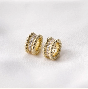 Macro detail of 14k gold-filled barrel bead with sparkling cubic zirconia inlay