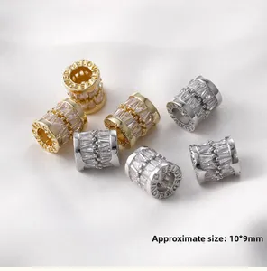 Macro view of 10x9mm cylinder charms with cubic zirconia and 'BELOVED' engraving