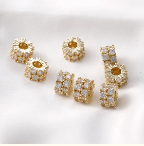 Macro detail of 14k gold plated spacer beads with micro-pave cubic zirconia on silk