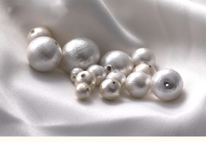 Macro detail of high-quality white cotton pearls with silk texture for DIY jewelry making