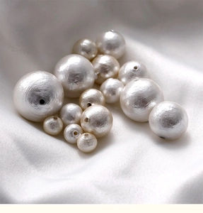 Close-up of premium white cotton pearls with silk texture for DIY jewelry making