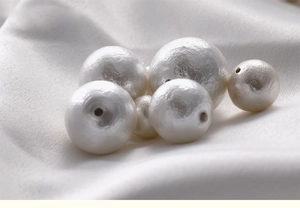 Macro shot of white cotton pearls with unique textured finish for DIY jewelry making