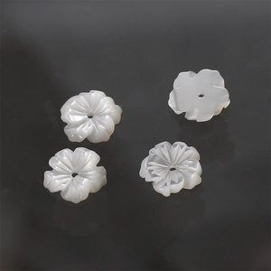 Detail of hand-carved white mother of pearl shell flower charms with center hole