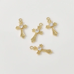 Detail showing four 14k gold-plated cross pendants with zircons for DIY jewelry making