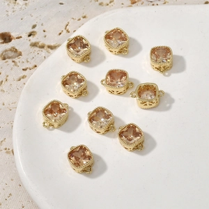 Close-up of square champagne zircon pendants with gold plated dual loops for DIY jewelry