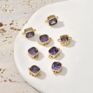 Detail of square purple zircon pendants with 14k gold plated settings and side hollow patterns