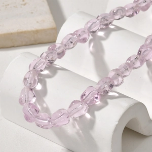 Close-up of translucent light purple ribbed glass beads for DIY jewelry making