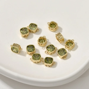 Macro shot of 14k gold plated square olive green zircon pendants for DIY jewelry making