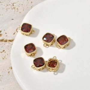Detailed macro view of five red square zircon pendants with 14k gold plated metal frames